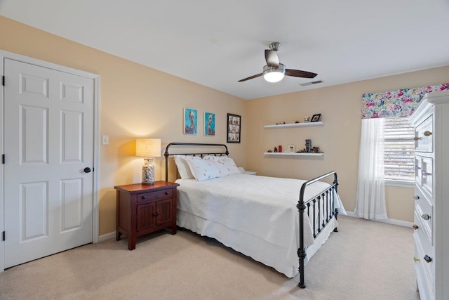 bedroom with visible vents, light colored carpet, a ceiling fan, and baseboards