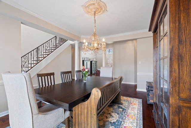 dining room featuring baseboards, decorative columns, dark wood-style flooring, stairs, and a notable chandelier