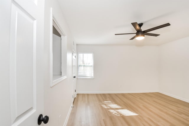 unfurnished room featuring ceiling fan, baseboards, and light wood-style flooring