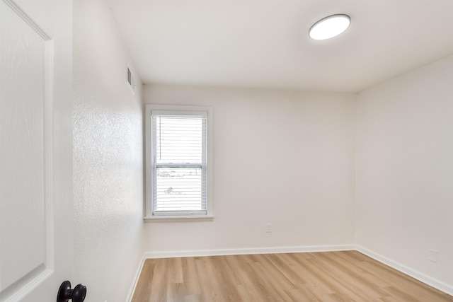 unfurnished room with wood finished floors and baseboards