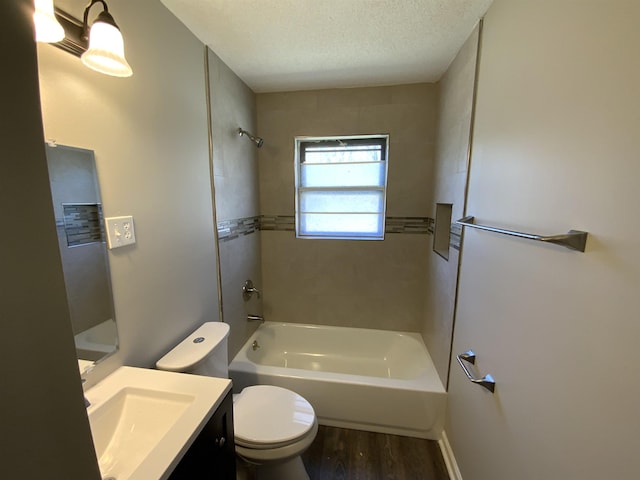 full bathroom featuring toilet, a textured ceiling, wood finished floors, shower / washtub combination, and vanity