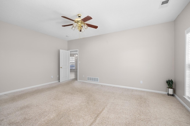 unfurnished room featuring ceiling fan, baseboards, visible vents, and light carpet