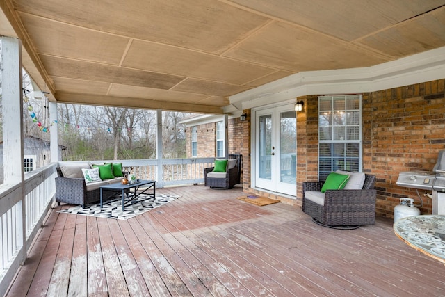 wooden terrace featuring french doors and outdoor lounge area