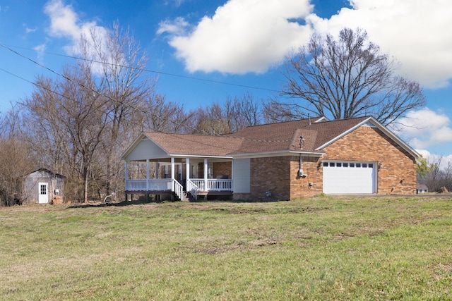 view of front facade with a garage, brick siding, a porch, and a front lawn