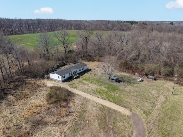 birds eye view of property with a rural view and a wooded view