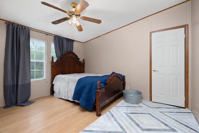 bedroom with a ceiling fan and light wood-style floors