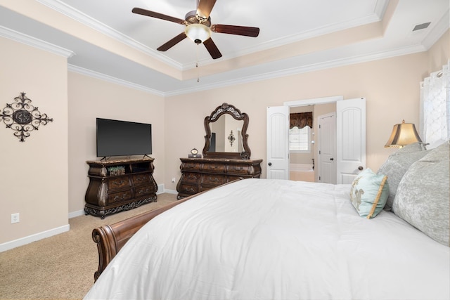 carpeted bedroom with visible vents, a raised ceiling, and baseboards