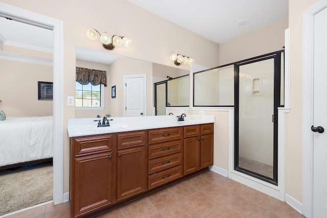 ensuite bathroom with double vanity, a stall shower, ensuite bath, and a sink