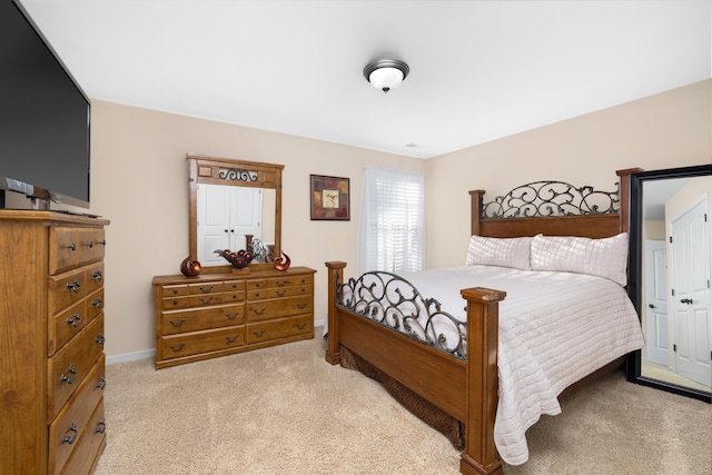 carpeted bedroom featuring baseboards