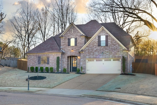 view of front of property featuring brick siding, a shingled roof, fence, concrete driveway, and an attached garage