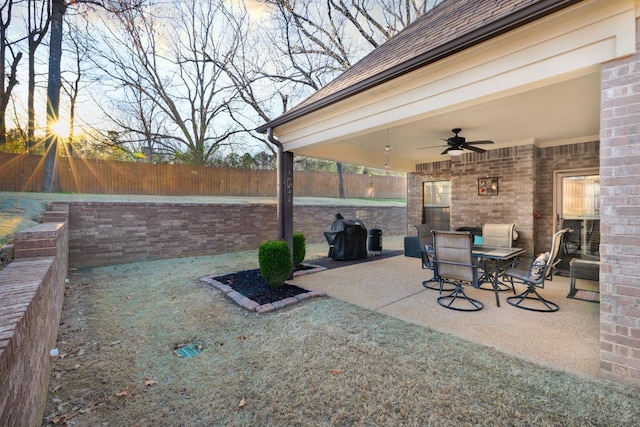 view of patio / terrace with ceiling fan and fence