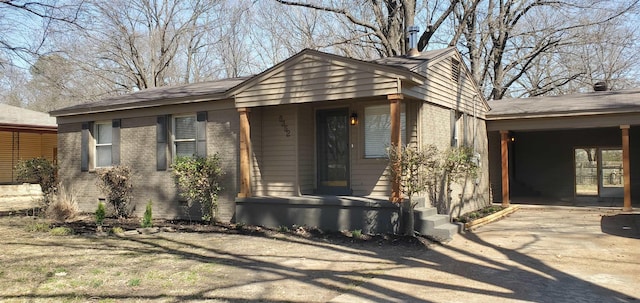 view of front of property featuring brick siding, crawl space, and concrete driveway