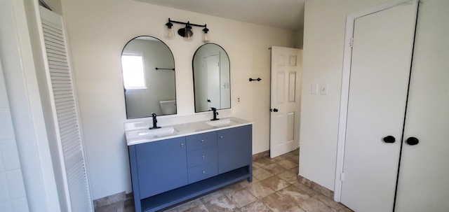 bathroom with a sink, a closet, toilet, and double vanity