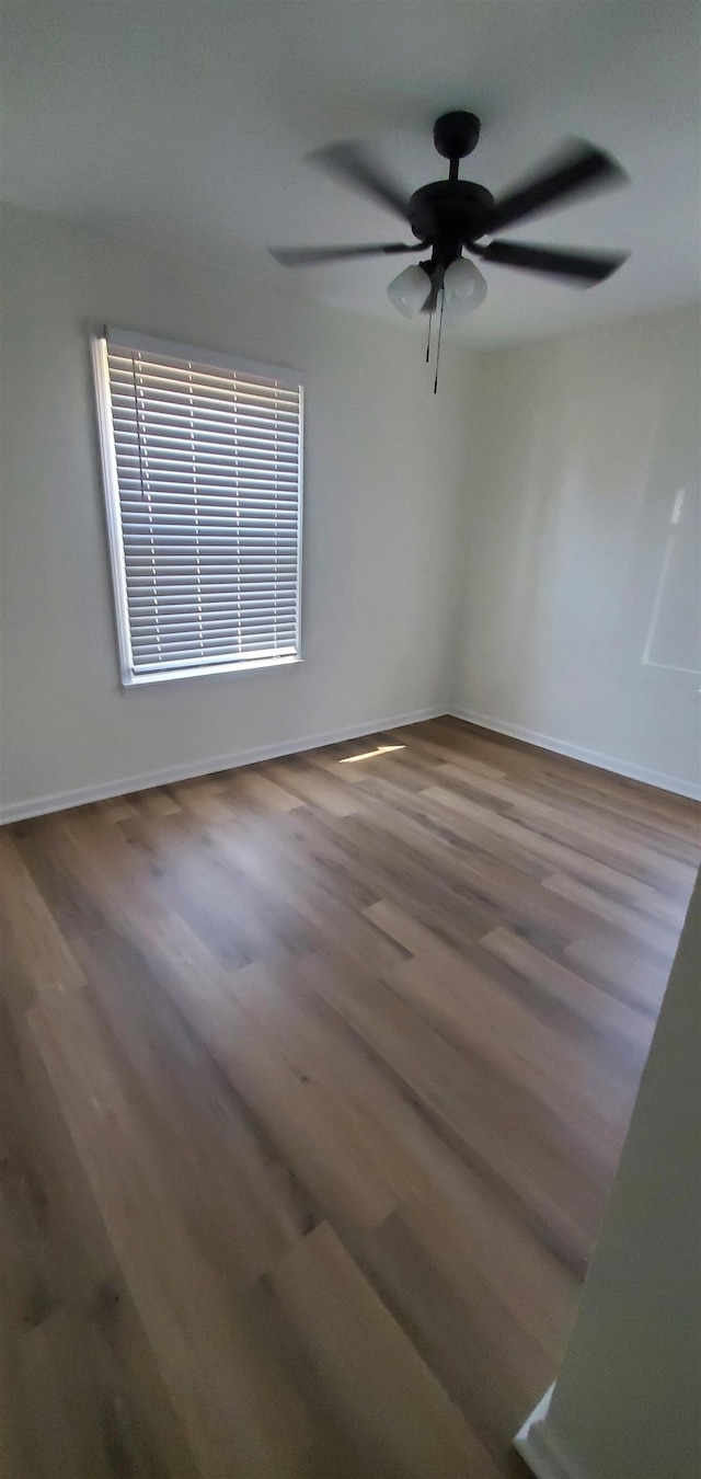 empty room with wood finished floors and baseboards