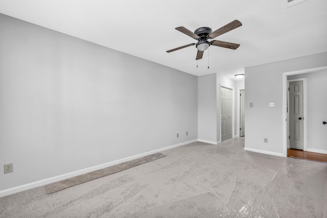 unfurnished bedroom with a ceiling fan, carpet, and baseboards