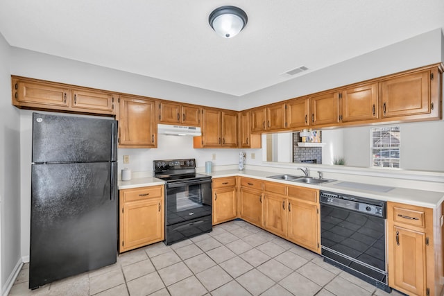 kitchen featuring visible vents, black appliances, under cabinet range hood, a sink, and light countertops