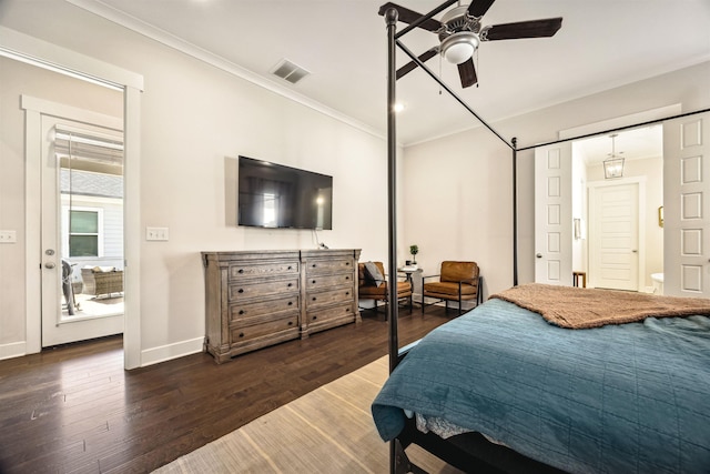 bedroom with visible vents, baseboards, wood finished floors, and ornamental molding