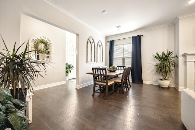 dining room with dark wood-style floors, baseboards, and ornamental molding