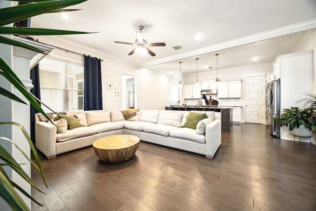 living room with visible vents, crown molding, and dark wood-style flooring