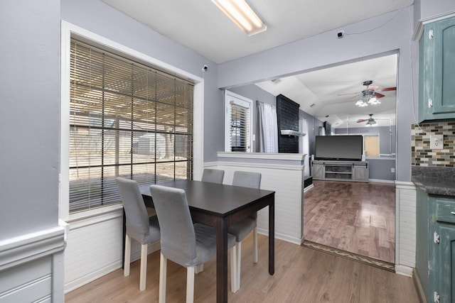 dining space with light wood-type flooring and ceiling fan