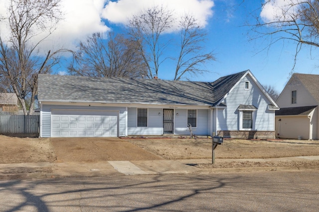 view of front facade featuring a garage, a shingled roof, driveway, and fence