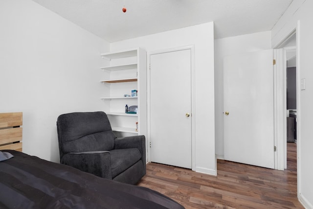 sitting room with wood finished floors and a textured ceiling