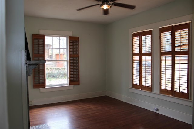 unfurnished room featuring ceiling fan, baseboards, and wood finished floors