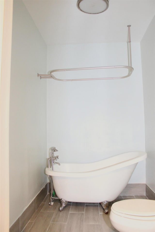 bathroom with a freestanding tub and toilet