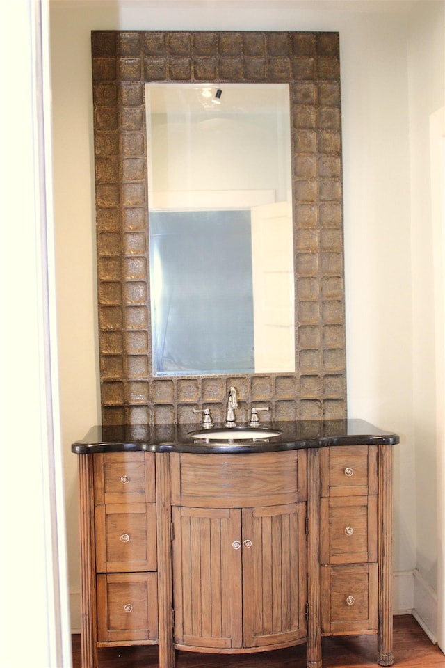 bathroom featuring baseboards and vanity