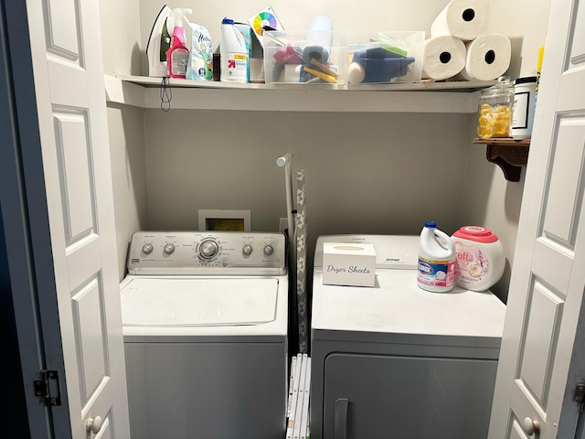 laundry room with washing machine and clothes dryer and laundry area