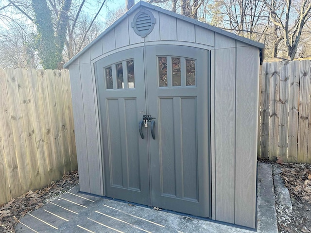 view of shed with fence