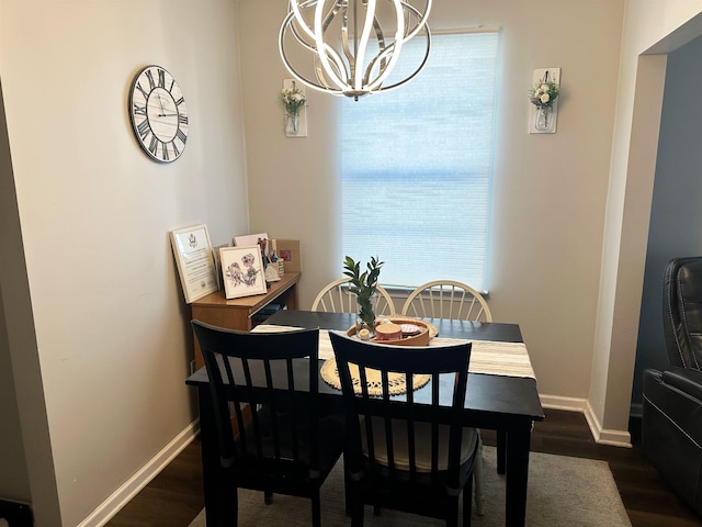 dining room with baseboards, dark wood-type flooring, and a chandelier