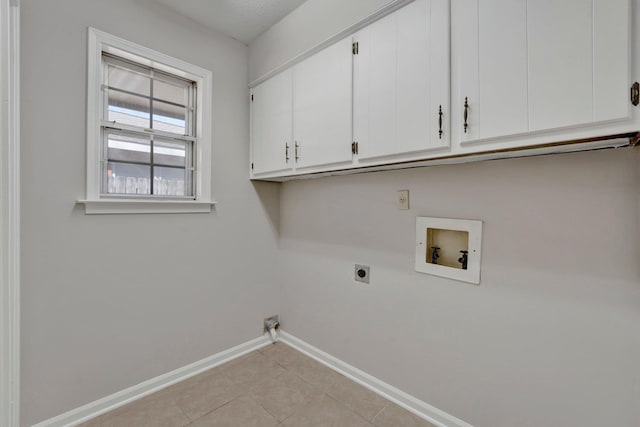 laundry room with baseboards, light tile patterned floors, hookup for a washing machine, cabinet space, and hookup for an electric dryer