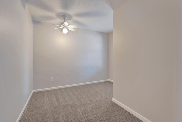 spare room featuring ceiling fan, a textured ceiling, baseboards, and carpet floors