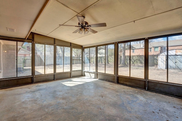 unfurnished sunroom featuring visible vents and ceiling fan