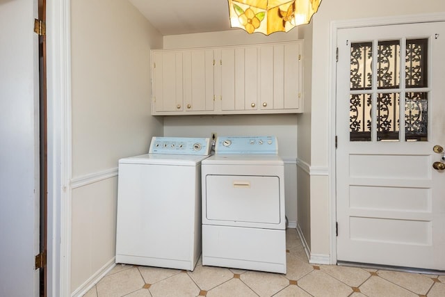 washroom featuring light tile patterned flooring, cabinet space, and independent washer and dryer