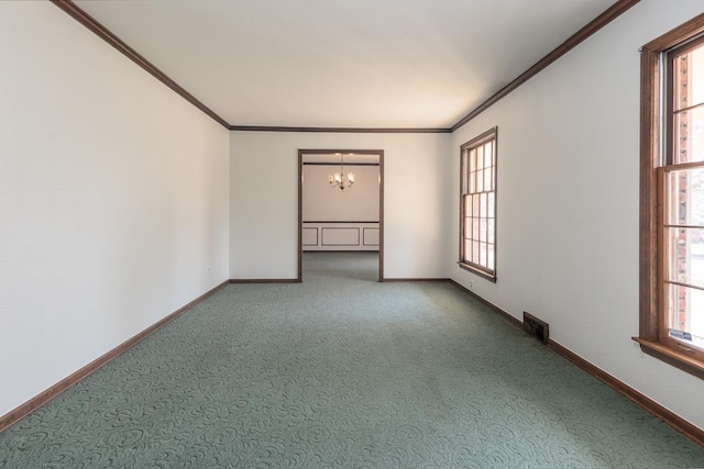 carpeted empty room featuring a wealth of natural light, baseboards, and ornamental molding