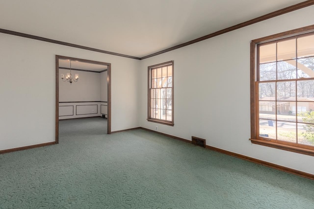 carpeted empty room featuring a notable chandelier, visible vents, baseboards, and ornamental molding