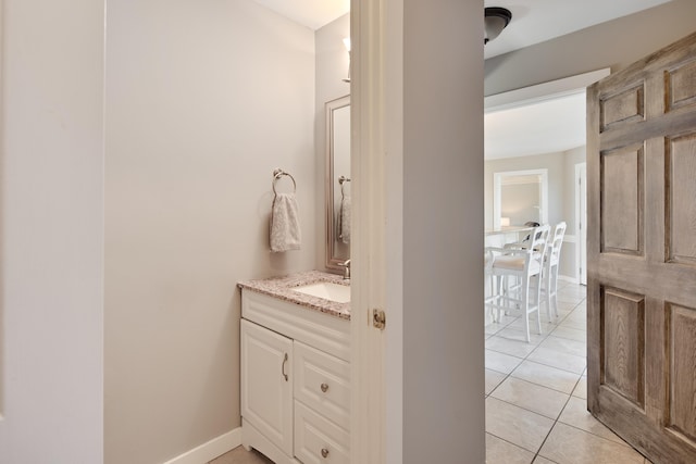 bathroom with tile patterned floors, vanity, and baseboards