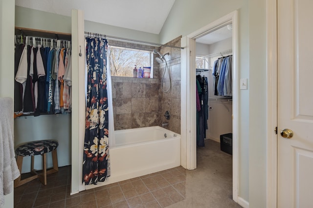 full bathroom with tile patterned floors, a walk in closet, lofted ceiling, and shower / bath combo