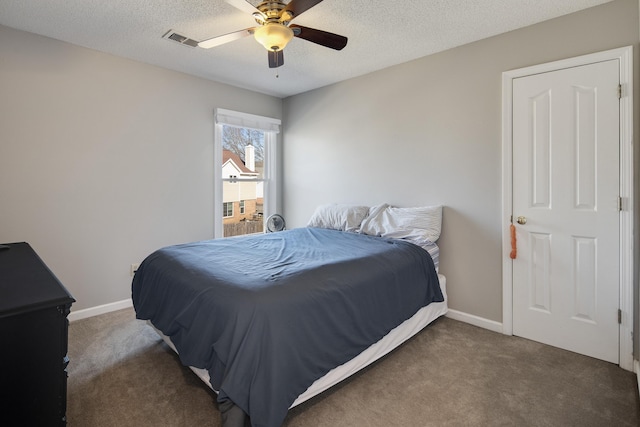 carpeted bedroom featuring ceiling fan, baseboards, visible vents, and a textured ceiling