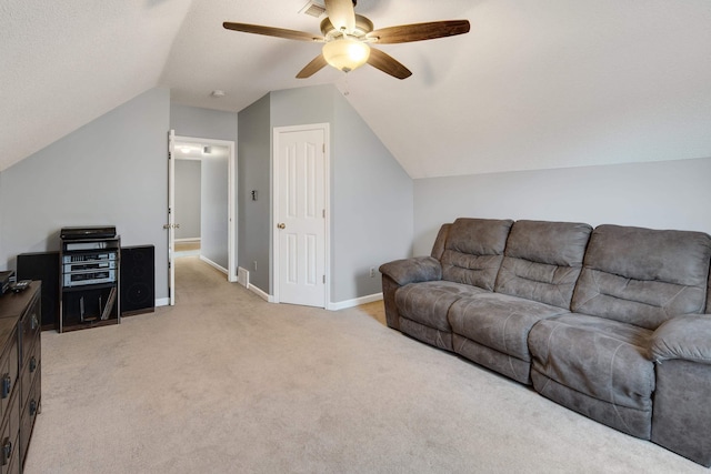 living area with vaulted ceiling, light colored carpet, baseboards, and ceiling fan