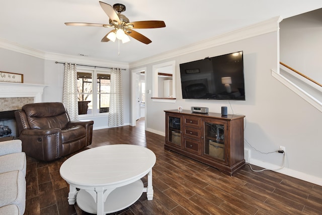 living room with a ceiling fan, wood finished floors, baseboards, a high end fireplace, and ornamental molding