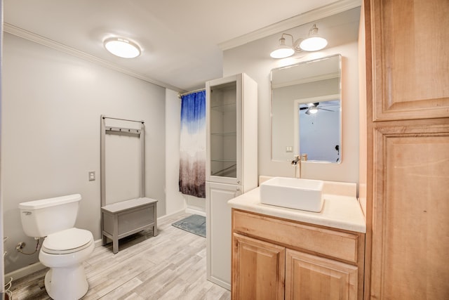 bathroom featuring wood finished floors, toilet, and ornamental molding