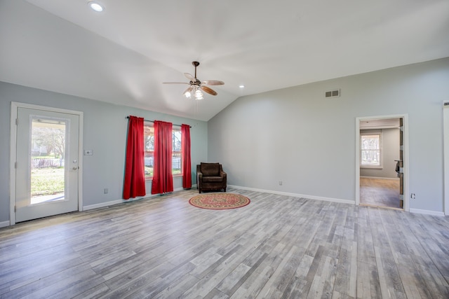 unfurnished room featuring visible vents, baseboards, ceiling fan, lofted ceiling, and wood finished floors