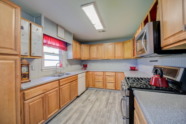 kitchen with a sink, visible vents, appliances with stainless steel finishes, and light countertops