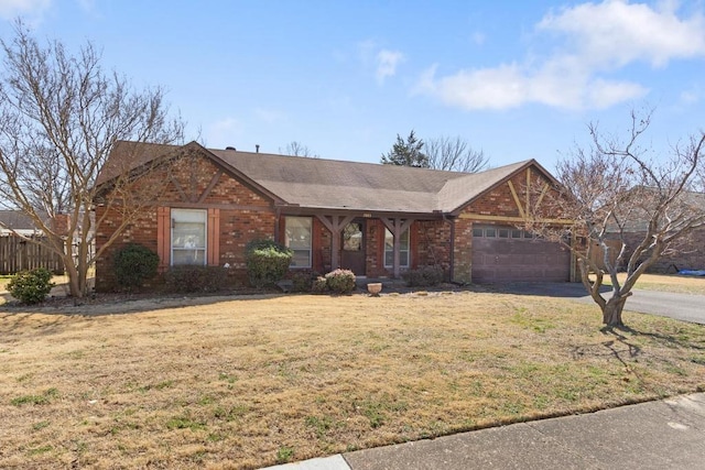 single story home featuring driveway, a front lawn, roof with shingles, a garage, and brick siding