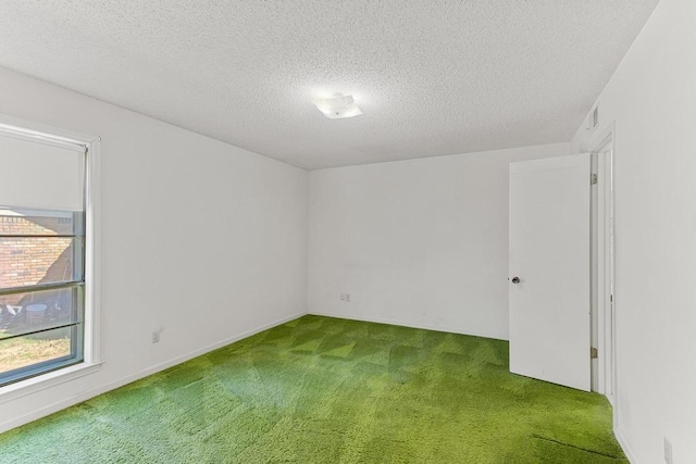 carpeted empty room featuring visible vents and a textured ceiling