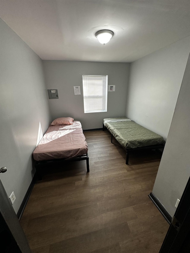 bedroom featuring baseboards and wood finished floors