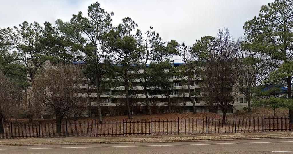 view of building exterior with fence